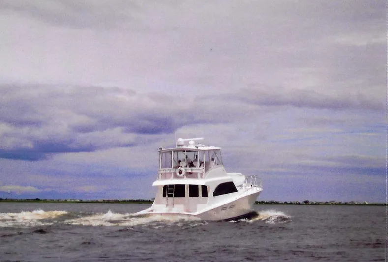 Irish Mist Yacht Photos Pics White 2001 Post 50 Convertible yacht cruising on open water under cloudy skies.