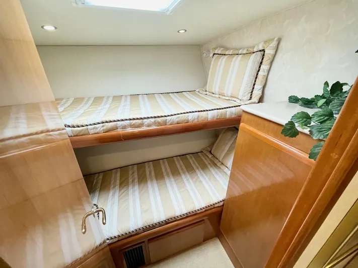 Irish Mist Yacht Photos Pics Interior of 2001 Post 50 Convertible yacht with bunk beds and wooden cabinetry.