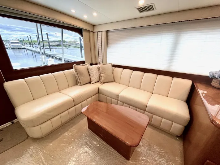 Irish Mist Yacht Photos Pics Luxurious interior of a 2001 Post 50 Convertible yacht with beige seating and wooden table.
