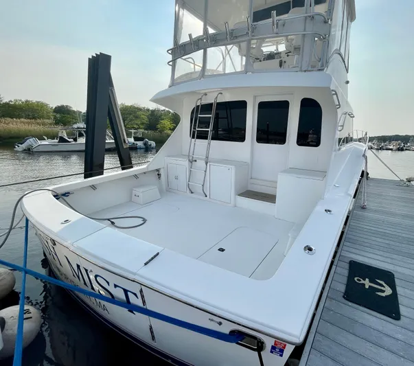 Irish Mist Yacht Photos Pics 2001 Post 50 Convertible yacht docked at marina, featuring spacious deck and upper helm.