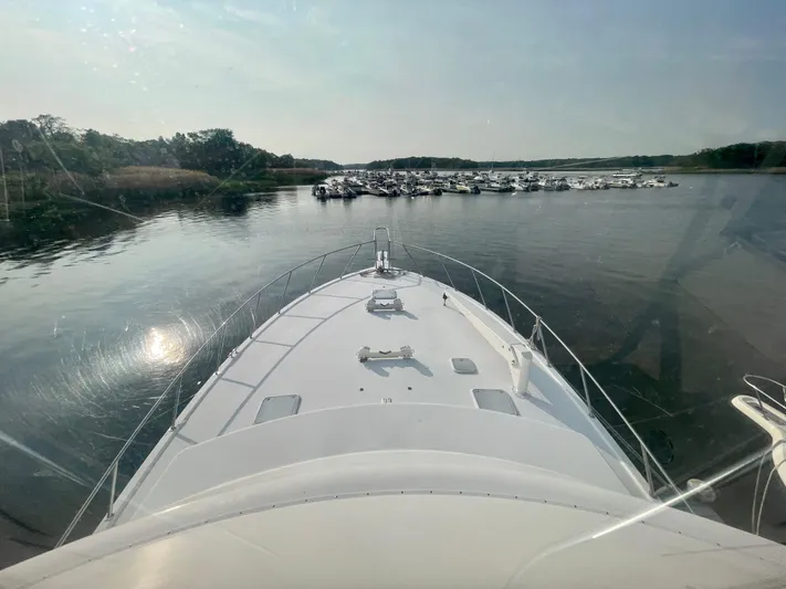 Irish Mist Yacht Photos Pics Bow view of 2001 Post 50 Convertible yacht approaching marina with docked boats.
