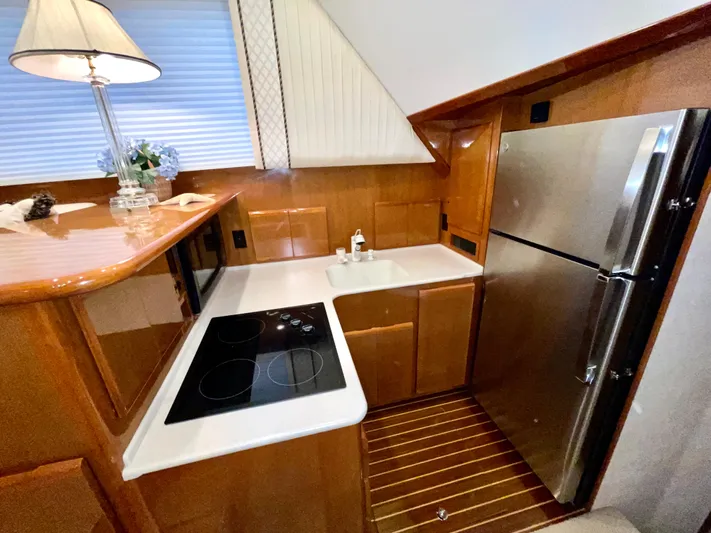 Irish Mist Yacht Photos Pics Luxurious yacht kitchen with modern appliances, wooden cabinetry, and sleek countertops in a 2001 Post 50 Convertible.
