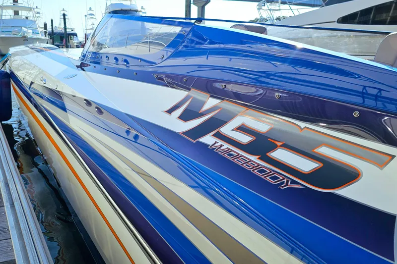  Yacht Photos Pics 2010 Daves Custom Boats M35, blue and white, docked at marina.