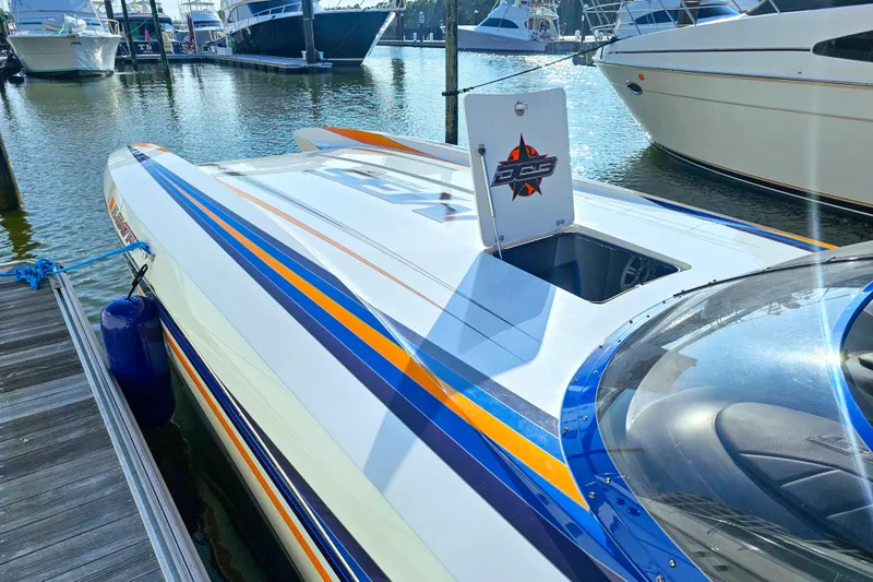  Yacht Photos Pics 2010 Daves Custom Boats M35 docked, featuring sleek design and vibrant stripes.