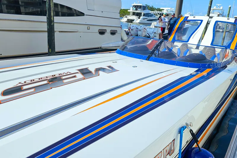  Yacht Photos Pics 2010 Daves Custom Boats M35 with vibrant stripes docked at marina.