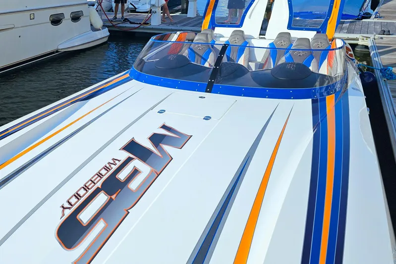  Yacht Photos Pics 2010 Daves Custom Boats M35 with vibrant stripes docked at marina.