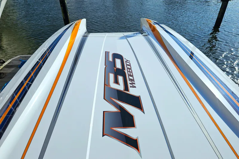  Yacht Photos Pics 2010 Daves Custom Boats M35 on water, showcasing sleek design and vibrant graphics.