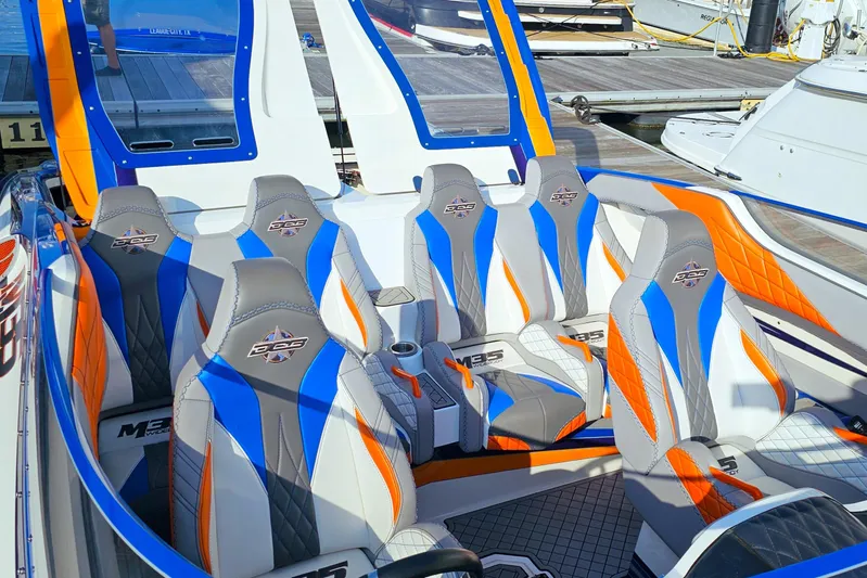  Yacht Photos Pics 2010 Daves Custom Boats M35 interior with vibrant blue and orange seating.