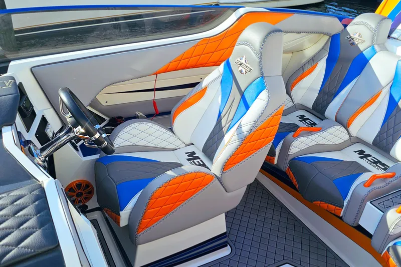  Yacht Photos Pics Interior of 2010 Daves Custom Boats M35 with vibrant orange, blue, and gray seating.