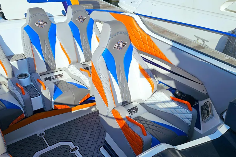  Yacht Photos Pics Interior of 2010 Daves Custom Boats M35 with vibrant blue, orange, and gray seating.