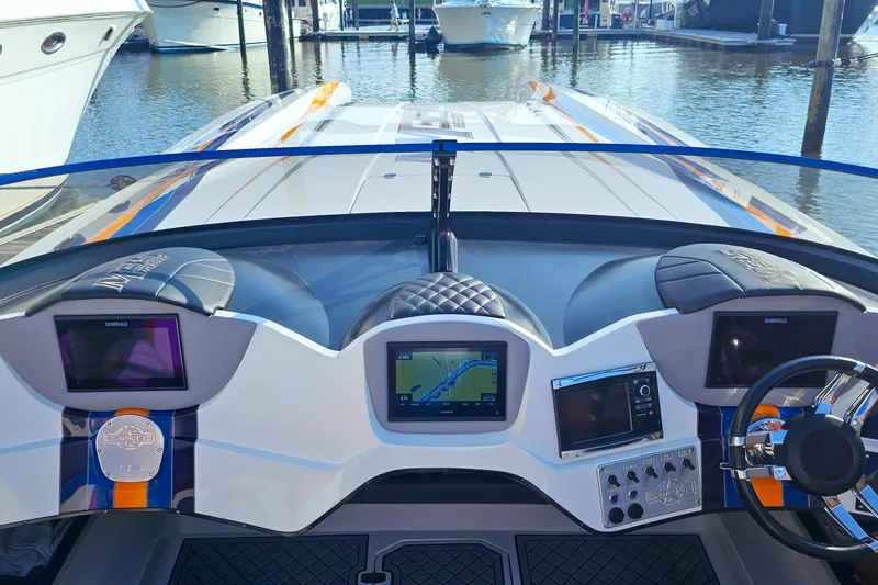  Yacht Photos Pics Cockpit view of 2010 Daves Custom Boats M35 with navigation screens and steering wheel.