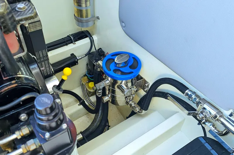  Yacht Photos Pics Engine compartment of 2010 Daves Custom Boats M35, featuring blue valve and hoses.