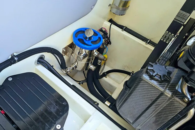  Yacht Photos Pics Engine compartment of 2010 Daves Custom Boats M35, featuring blue valve and hoses.