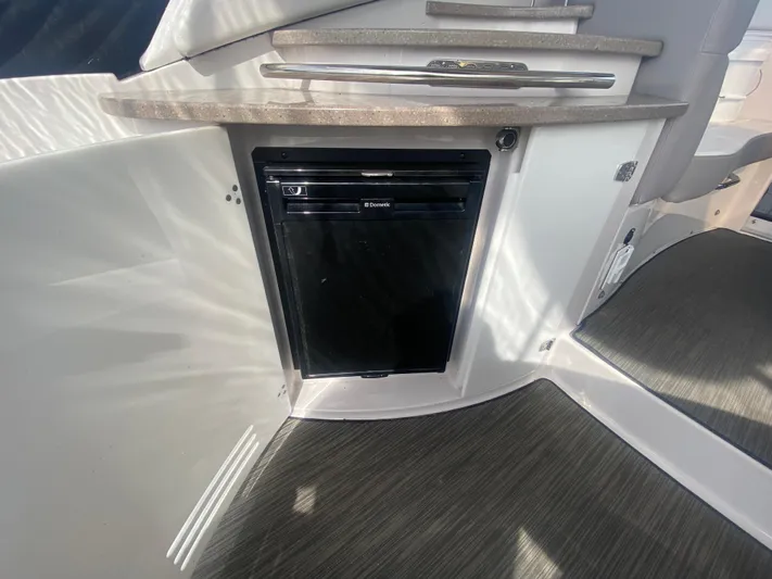 The Mint Yacht Photos Pics 2018 Four Winns 355 Vista boat interior with compact fridge and countertop.
