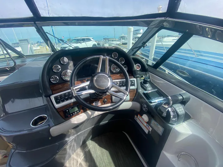 The Mint Yacht Photos Pics 2018 Four Winns 355 Vista boat cockpit with steering wheel and control panel.