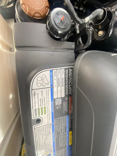 The Mint Yacht Photos Pics Close-up of a 2018 Four Winns 355 Vista engine with Mercury maintenance label.