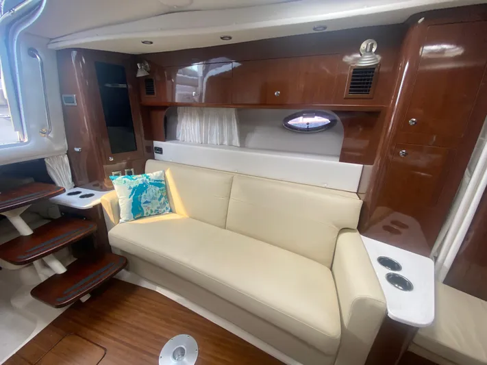 The Mint Yacht Photos Pics Luxurious interior of 2018 Four Winns 355 Vista yacht with cream sofa and wooden accents.