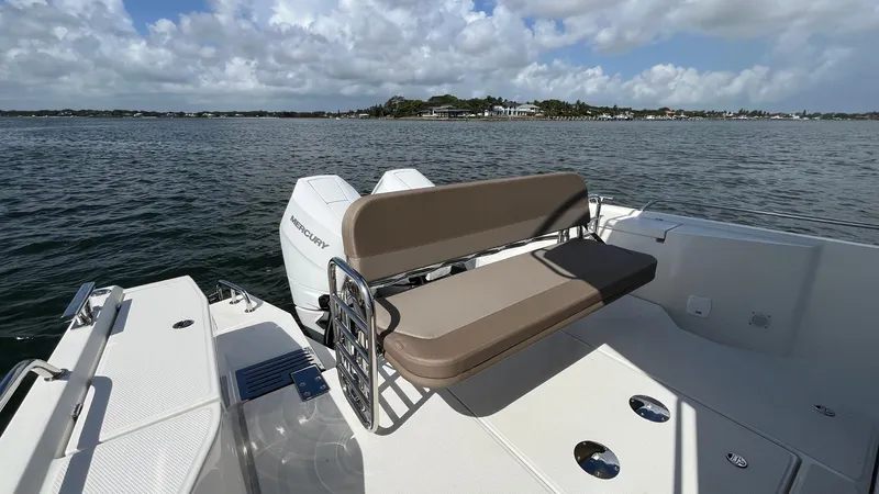 In- Stock 2025 Nimbus C11 #086 Yacht Photos Pics Nimbus Commuter 11 #086 boat, 2025 model, with seating, on a calm water body.
