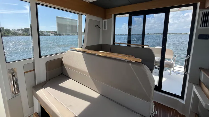 In- Stock 2025 Nimbus C11 #086 Yacht Photos Pics Interior of 2025 Nimbus Commuter 11 boat with seating and scenic water view.