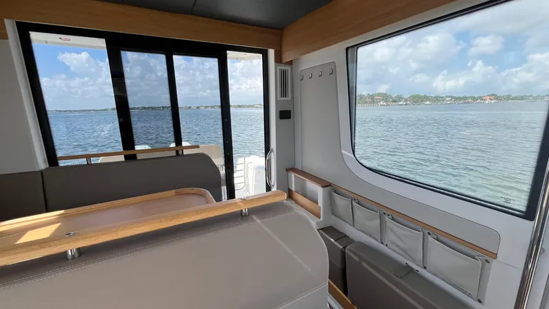 In- Stock 2025 Nimbus C11 #086 Yacht Photos Pics Interior view of Nimbus Commuter 11 #086, 2025 model, overlooking serene waters.