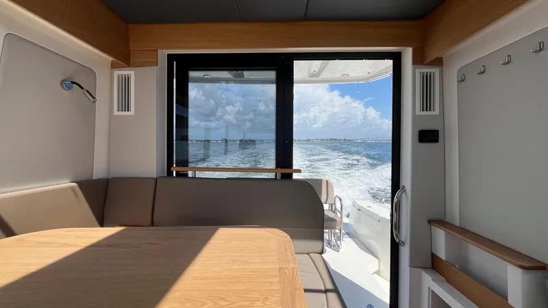 In- Stock 2025 Nimbus C11 #086 Yacht Photos Pics Interior view of 2025 Nimbus Commuter 11 #086 yacht with ocean backdrop.