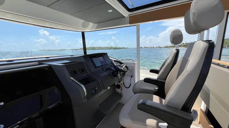 In- Stock 2025 Nimbus C11 #086 Yacht Photos Pics Interior of 2025 Nimbus Commuter 11 boat with modern cockpit and ocean view.