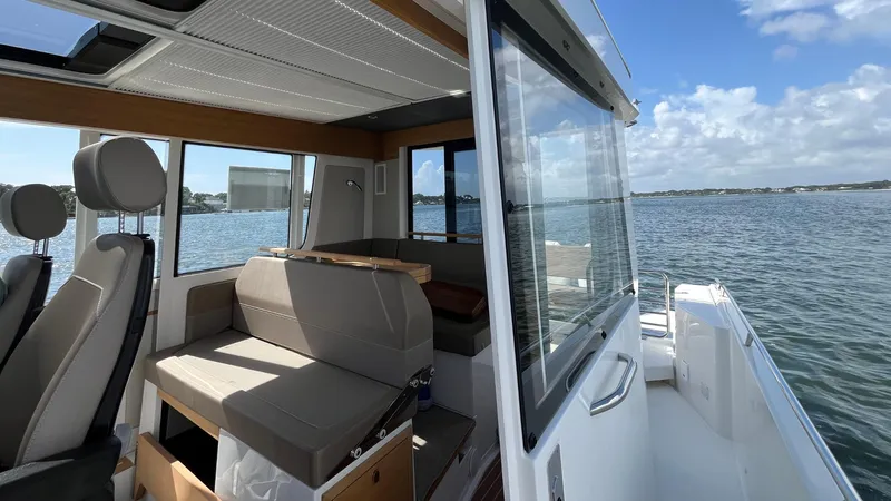 In- Stock 2025 Nimbus C11 #086 Yacht Photos Pics Modern Nimbus Commuter 11 boat interior with seating, overlooking serene waters, 2025 model.