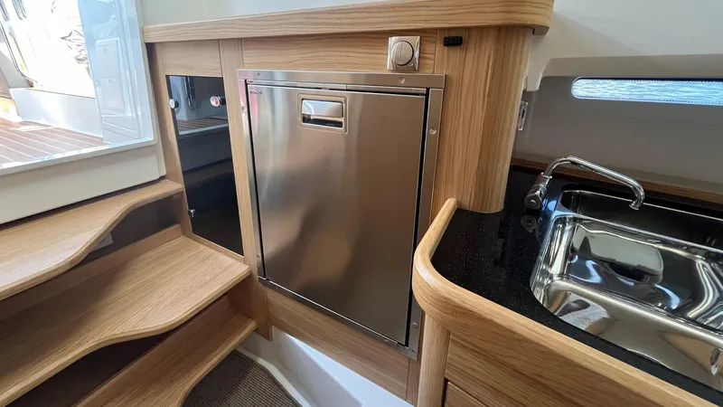 In- Stock 2025 Nimbus C11 #086 Yacht Photos Pics Modern kitchen area in 2025 Nimbus Commuter 11 boat with stainless steel appliances.