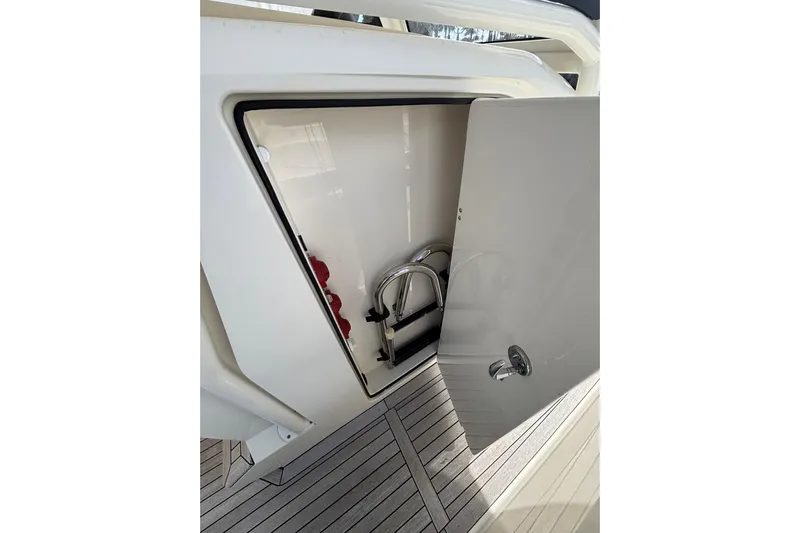  Yacht Photos Pics Open storage compartment on 2018 Ocean 1 R boat with visible ladder and equipment.