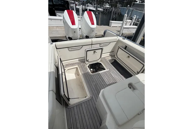  Yacht Photos Pics 2018 Ocean 1 R boat interior with open storage compartments and twin engines at dock.