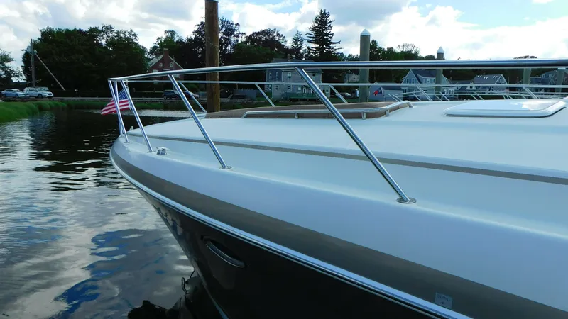  Yacht Photos Pics 2003 Formula 40 PC boat docked on calm water with American flag.