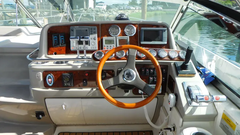  Yacht Photos Pics 2003 Formula 40 PC boat dashboard with wooden steering wheel and navigation instruments.