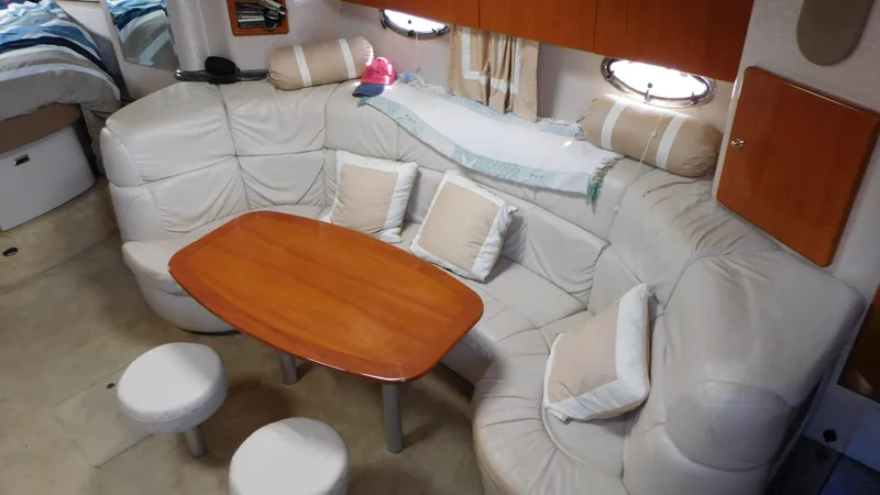  Yacht Photos Pics 2003 Formula 40 PC yacht interior with plush seating and wooden table.