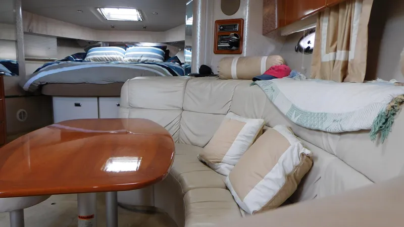  Yacht Photos Pics Interior of 2003 Formula 40 PC yacht with cozy seating and elegant wooden table.