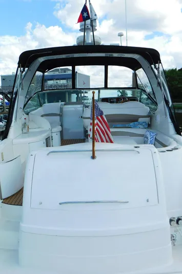  Yacht Photos Pics 2003 Formula 40 PC yacht with American flag, docked under a partly cloudy sky.