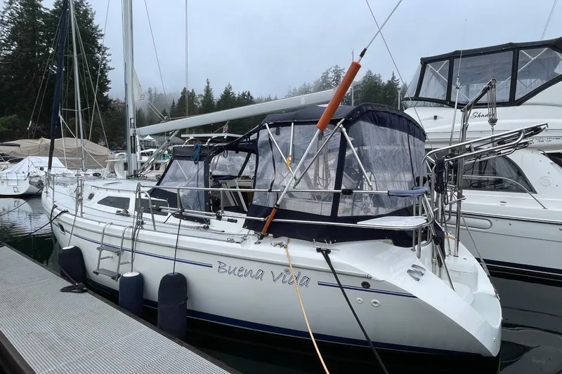 Buena Vida Yacht Photos Pics Catalina 42 MkII 2000 sailboat docked, named "Buena Vida," with misty forest background.