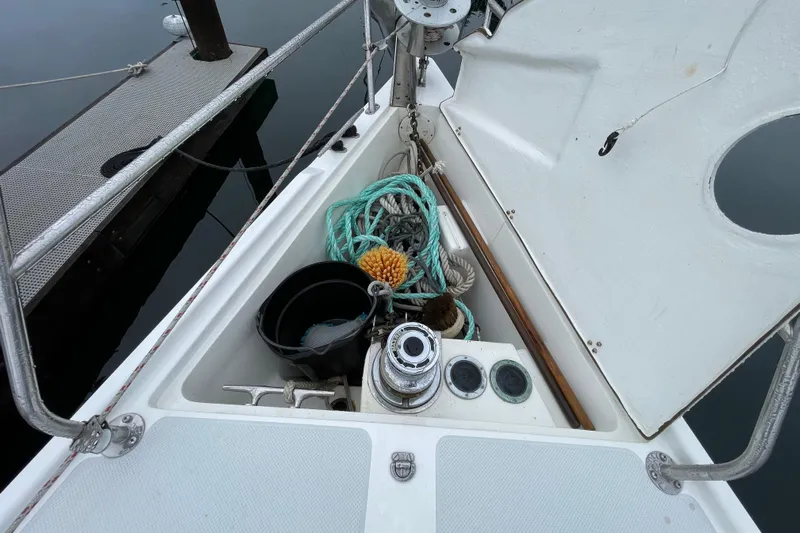 Buena Vida Yacht Photos Pics Open storage compartment on 2000 Catalina 42 MkII sailboat with ropes and cleaning supplies.