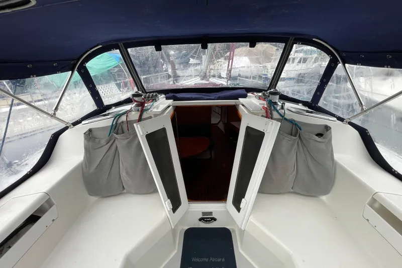 Buena Vida Yacht Photos Pics Cockpit view of 2000 Catalina 42 MkII sailboat with open cabin doors.