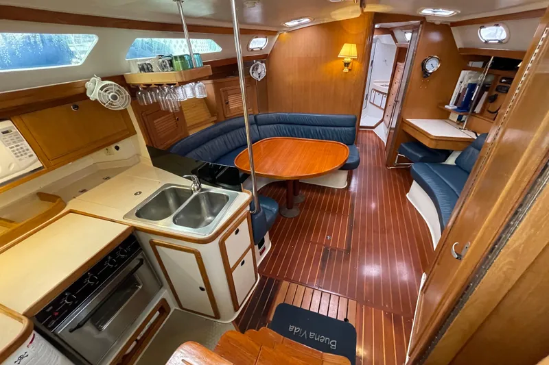 Buena Vida Yacht Photos Pics Interior of 2000 Catalina 42 MkII sailboat with wood finish and cozy seating area.