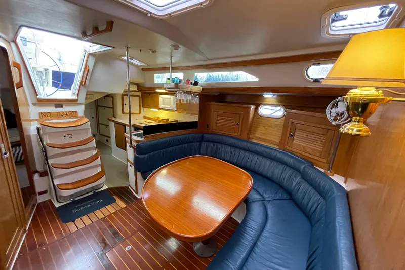 Buena Vida Yacht Photos Pics Interior of 2000 Catalina 42 MkII sailboat with cozy seating and wooden finishes.
