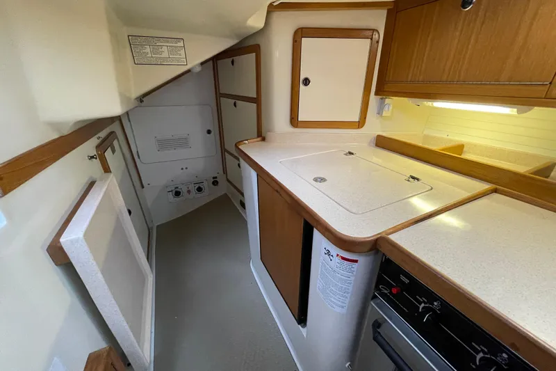 Buena Vida Yacht Photos Pics Interior of a 2000 Catalina 42 MkII sailboat, featuring a compact kitchen area.