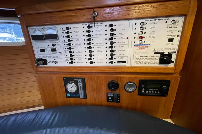 Buena Vida Yacht Photos Pics Control panel of a 2000 Catalina 42 MkII yacht, featuring various switches and gauges.