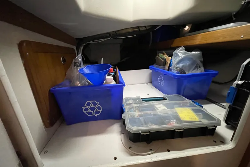 Buena Vida Yacht Photos Pics Storage area in a 2000 Catalina 42 MkII sailboat with organized recycling bins and toolbox.