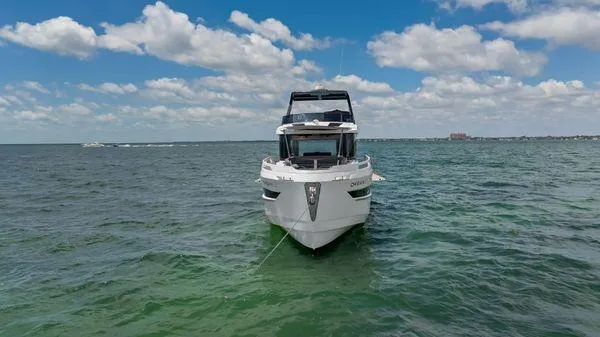  Yacht Photos Pics 2024 OKEAN 52 yacht on open water under a partly cloudy sky.