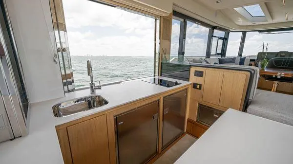  Yacht Photos Pics 2024 OKEAN 52 yacht interior with modern kitchen and ocean view.