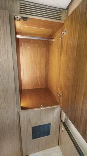  Yacht Photos Pics 2024 OKEAN 52 yacht interior wooden storage cabinet with open doors.