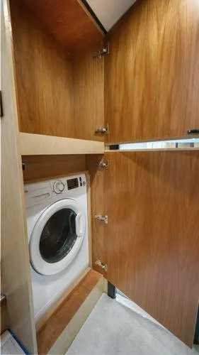  Yacht Photos Pics Built-in washing machine in 2024 OKEAN 52 yacht's wooden cabinet.