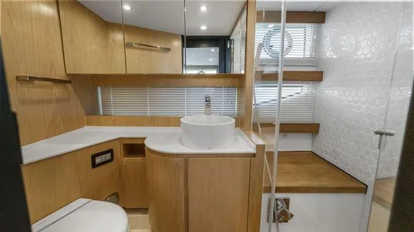  Yacht Photos Pics Modern bathroom in 2024 OKEAN 52 yacht with wood accents and sleek fixtures.