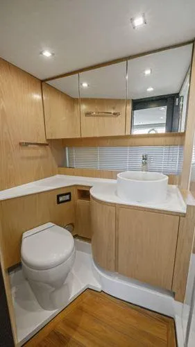  Yacht Photos Pics Modern bathroom interior on 2024 OKEAN 52 yacht with wood accents and sleek fixtures.