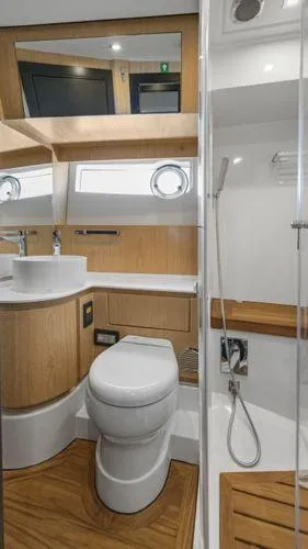  Yacht Photos Pics 2024 OKEAN 52 yacht bathroom with modern fixtures and wooden accents.